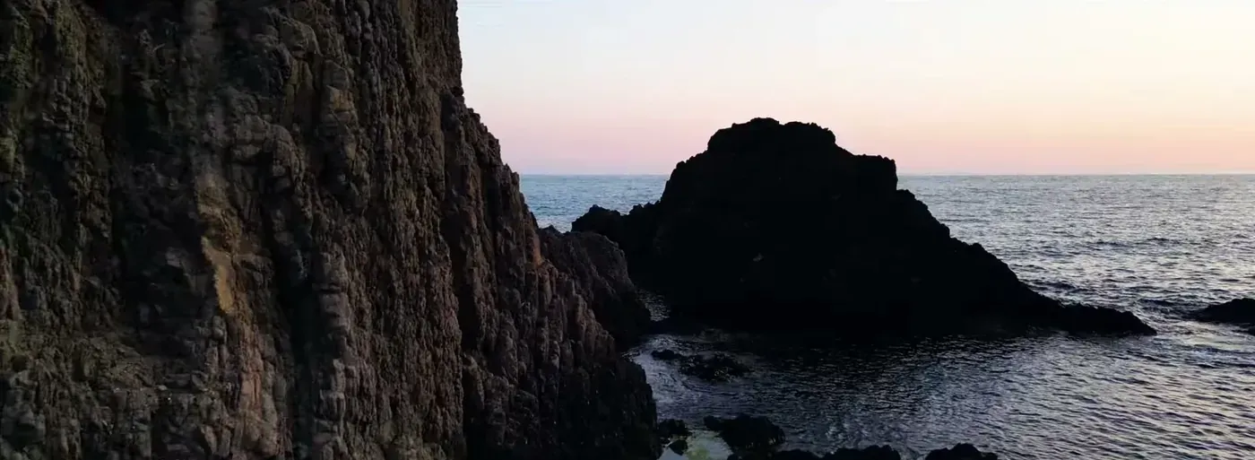 Volcanic rocks and the Mediterranean sea at sunset