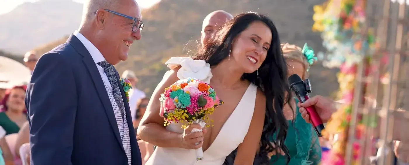 Bride arriving on her father’s arm in warm golden light
